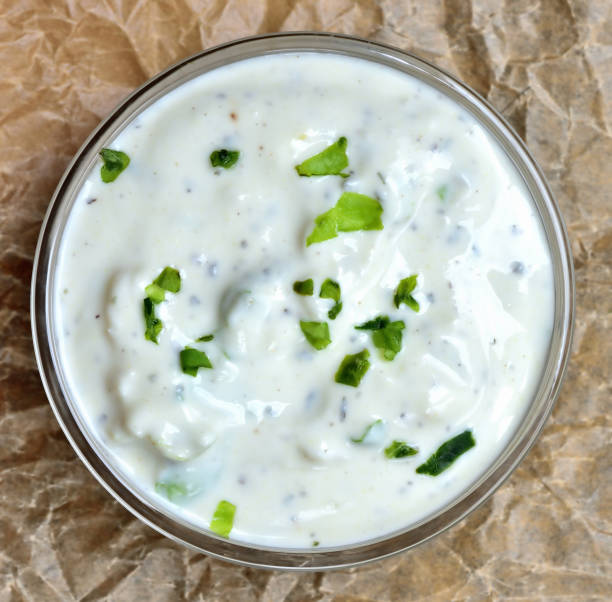 Homemade garlic yogurt dip sauce with herbs. View from top. stock photo