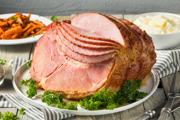 Homemade Glazed Easter Spiral Cut Ham Homemade Glazed Easter Spiral Cut Ham with Carrots and Potatoes ham stock pictures, royalty-free photos & images