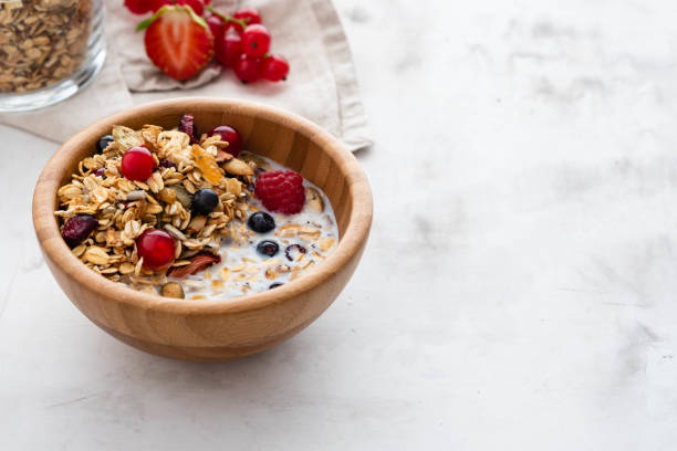 Homemade granola in bowl rustic background. Copy space. stock photo