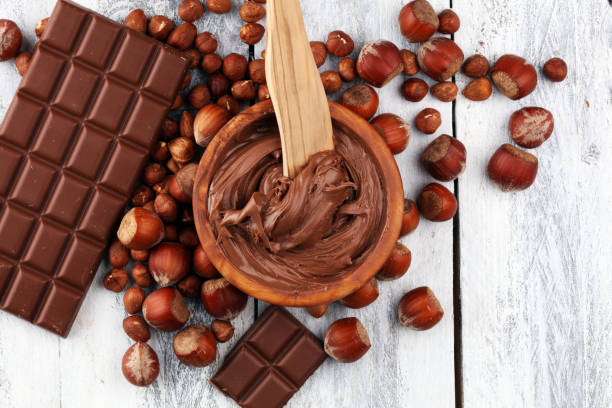 Homemade hazelnut chocolate spread in wooden bowl. Hazelnut Nougat cream stock photo