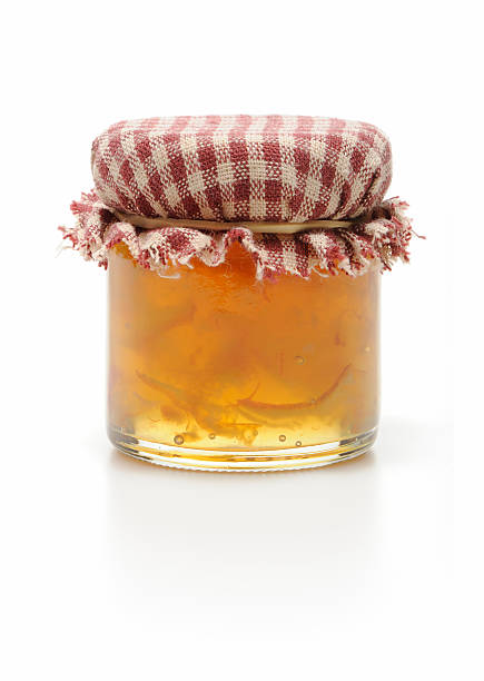 Homemade jar of marmalade isolated in white Small jar of homemade orange marmalade isolated on white marmalade stock pictures, royalty-free photos & images