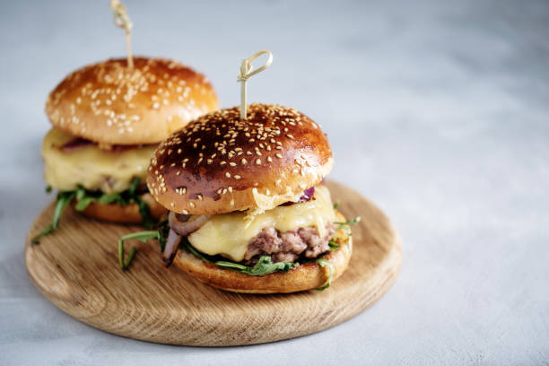 Homemade juicy burger with beef, cheese and caramelized onions. Street food, fast food. Copyspace. stock photo