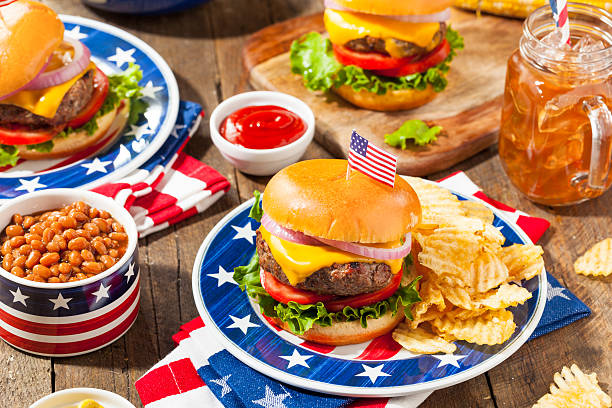 Homemade Memorial Day Hamburger Picnic Homemade Memorial Day Hamburger Picnic with Chips and Fruit food 4th of july stock pictures, royalty-free photos & images