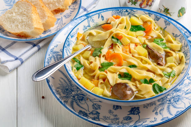 Homemade noodles with chicken broth and vegetables. stock photo