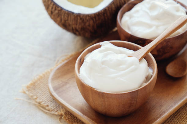 homemade organic coconut greek yogurt in wooden bowl stock photo