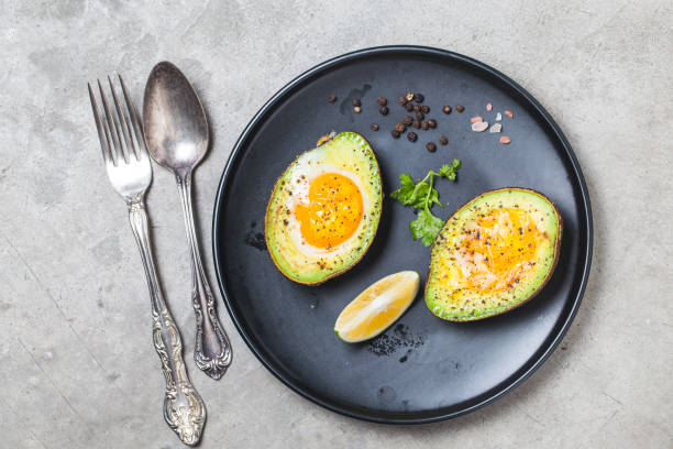 Homemade Organic Egg Baked in Avocado with Salt and Pepper stock photo