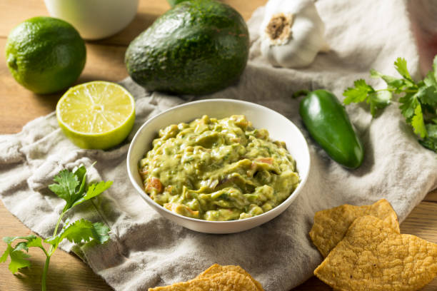 Homemade Organic Guacamole and Chips Homemade Organic Guacamole and Chips with Lime guacamole stock pictures, royalty-free photos & images