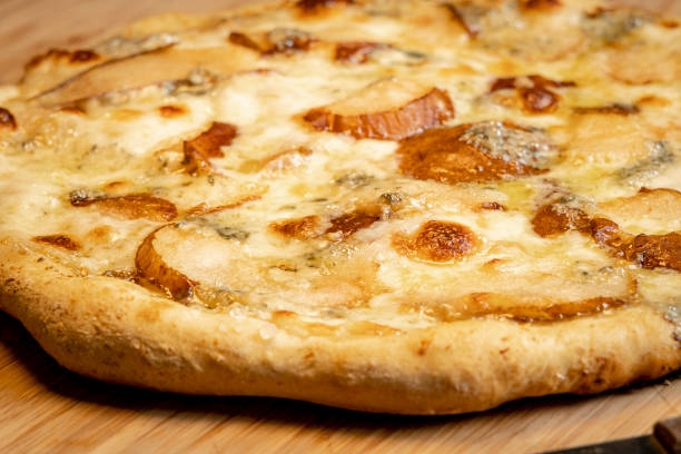 homemade pear and blue cheese pizza macro close up stock photo