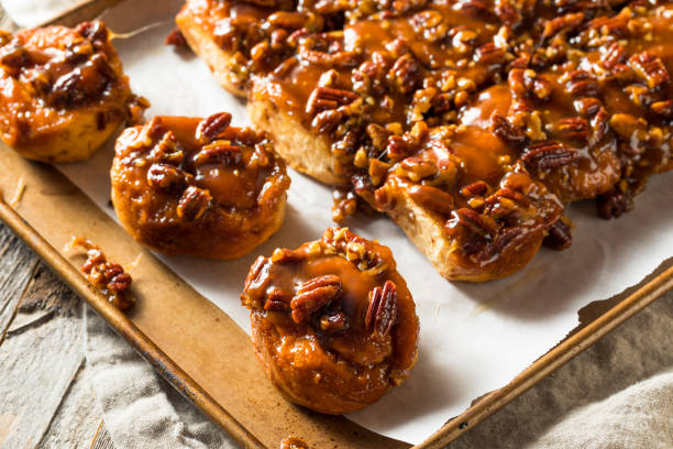 Homemade Pecan Schnecken Sticky Buns Homemade Pecan Schnecken Sticky Buns Ready to Eat sticky stock pictures, royalty-free photos & images