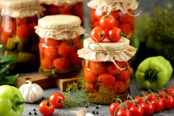 Homemade pickled cherry tomatoes with dill and garlic. stock photo