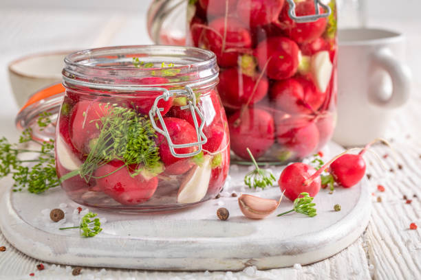 Homemade pickled radishes made of vegetables from backyard greenhouse. stock photo