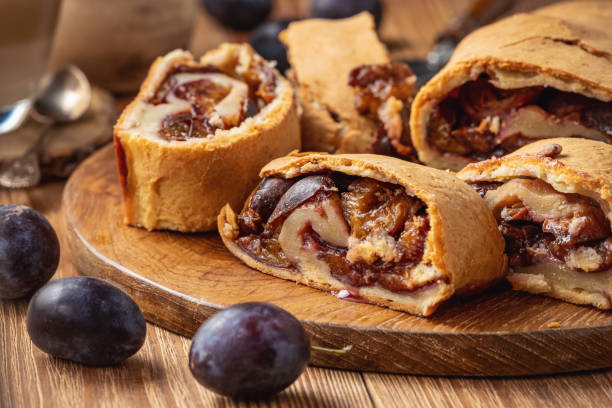 Homemade plum roll cake, strudel with plum filling. stock photo