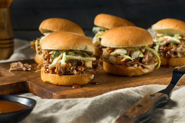 Homemade Pulled Pork Sliders Homemade Pulled Pork Sliders with Barbecue Sauce sliding stock pictures, royalty-free photos & images