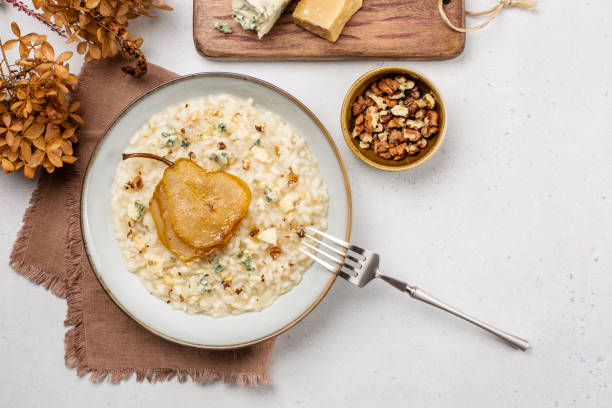 Homemade risotto with gorgonzola cheese, pear and walnuts. stock photo