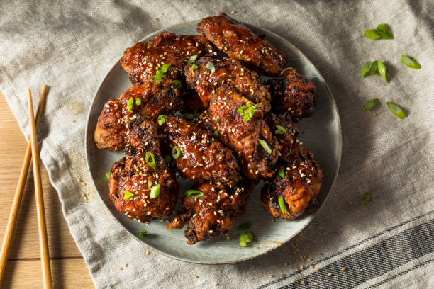 Homemade Spicy Korean Chicken Wings Homemade Spicy Korean Chicken Wings with Sesame Seeds korean culture photos stock pictures, royalty-free photos & images