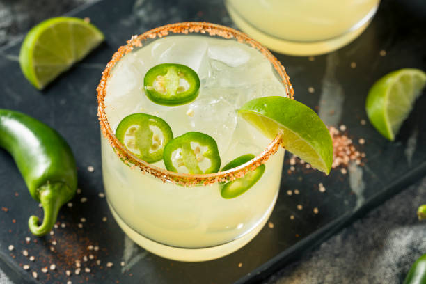 Homemade Spicy Margarita with Limes Homemade Spicy Margarita with Limes and Jalapenos Spicy Margarita stock pictures, royalty-free photos & images