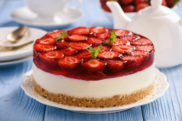 Homemade strawberry cheesecake on blue wooden background. stock photo