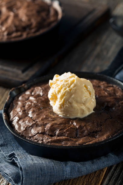 Homemade Sweet Dark Chocolate Brownie in a Skillet Homemade Sweet Dark Chocolate Brownie in a Skillet Ready to Eat semi sweet chocolate stock pictures, royalty-free photos & images
