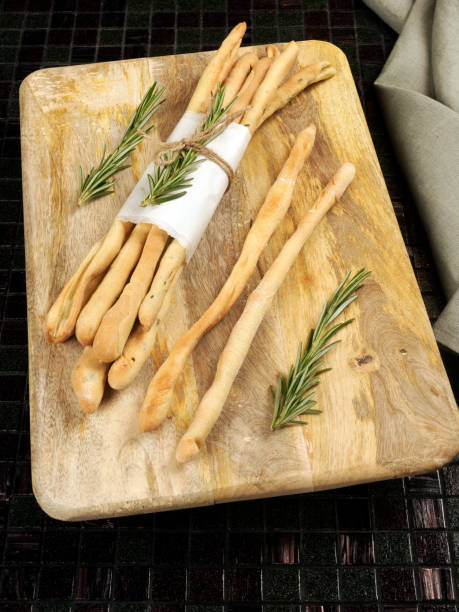 Homemade traditional italian appetizer grissini breadsticks with rosemary stock photo