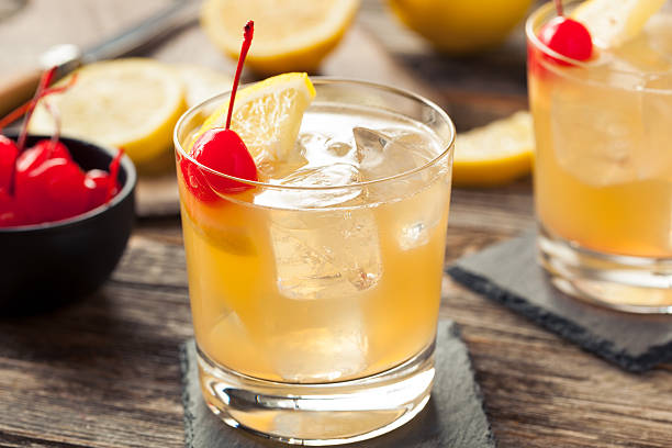 Homemade Whiskey Sour Cocktail Drink Homemade Whiskey Sour Cocktail Drink with a Cherry Lemon sour taste stock pictures, royalty-free photos & images