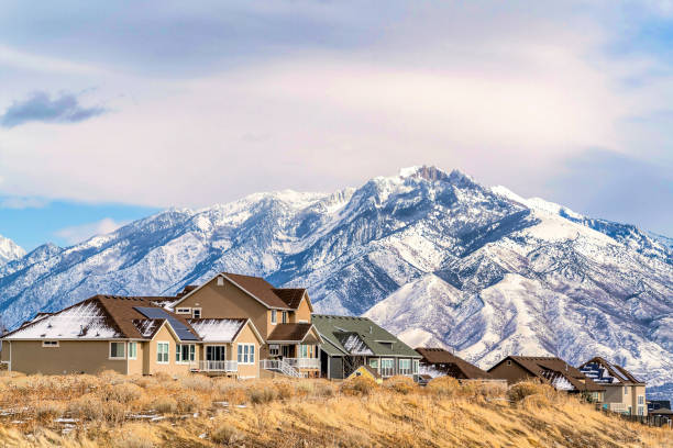 Homes with solar panels on roof against magnificent snowy Wasatch Mountain view stock photo