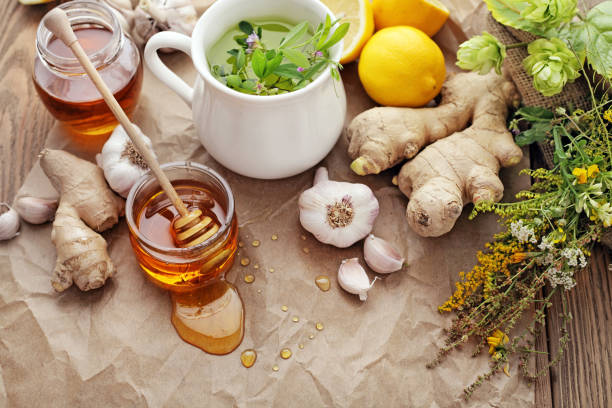 Honey, garlic, herbs, lemon and ginger - natural medicine, healthy food stock photo