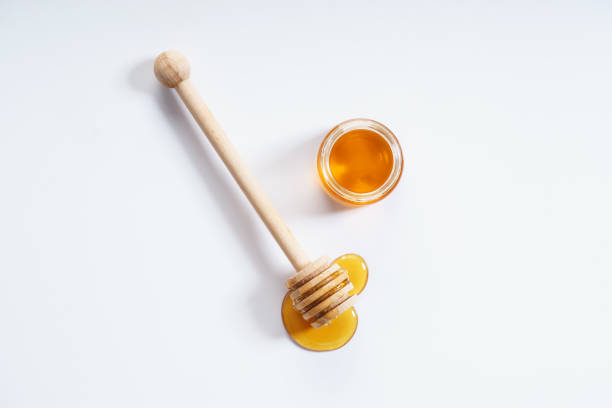 honey honey dipper and honey jar on white background honey stock pictures, royalty-free photos & images