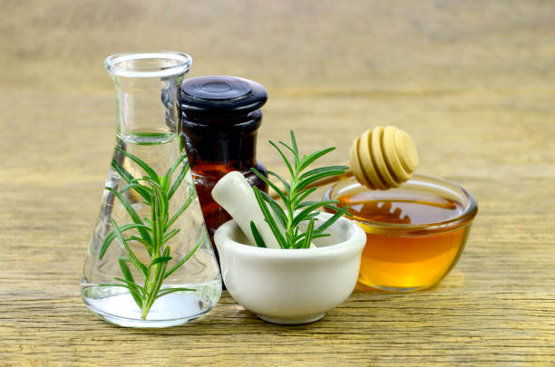Honey, rosemary and essential oil for homeopathy remedy. stock photo