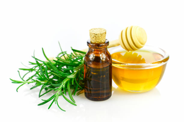 Honey, rosemary and essential oil homeopathy remedy recipe on white background. stock photo
