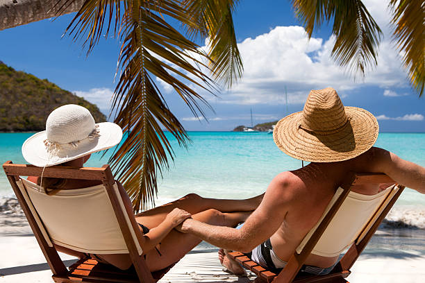 honeymoon couple relaxing at a Caribbean beach on summer vacation stock photo