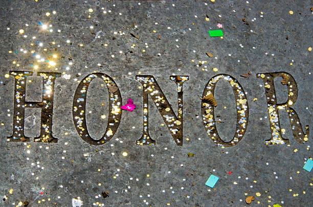 Honor Spelled Out with Sparkling Confetti The word "Honor" is embedded in the conrete walkway at Baylor University in Waco, Texas.  Sparkling confetti is scattered across the picture, leftovers from a graduation ceremony. baylor basketball stock pictures, royalty-free photos & images