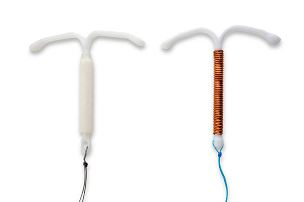 Hormonal and Copper IUD. Two different types of Intrauterine Device (IUD), copper and hormonal, such as Mirena or Skyla. iud stock pictures, royalty-free photos & images
