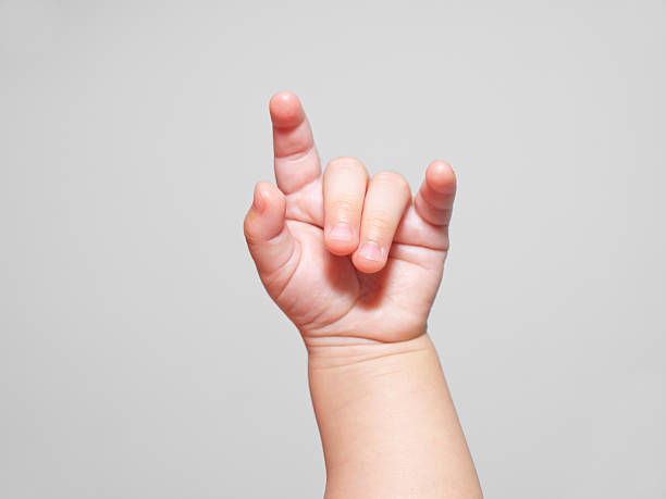Horns up! baby hand gesturing horns up rock and roll symbol sign language stock pictures, royalty-free photos & images