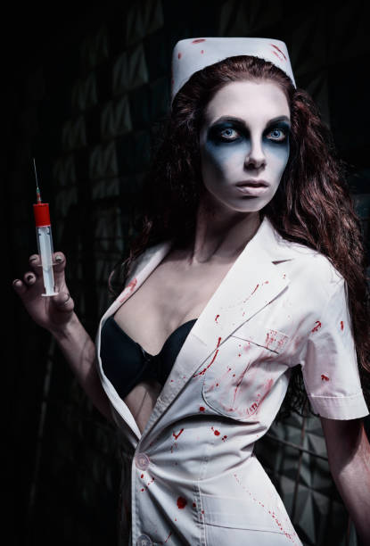 Horror shot: strange mad nurse (doctor) in bloody uniform, with syringe in hand. Zombie woman (living dead) Horror shot: the strange mad nurse (doctor) in bloody uniform, with syringe in hand. Zombie woman (living dead) ugly skinny women stock pictures, royalty-free photos & images