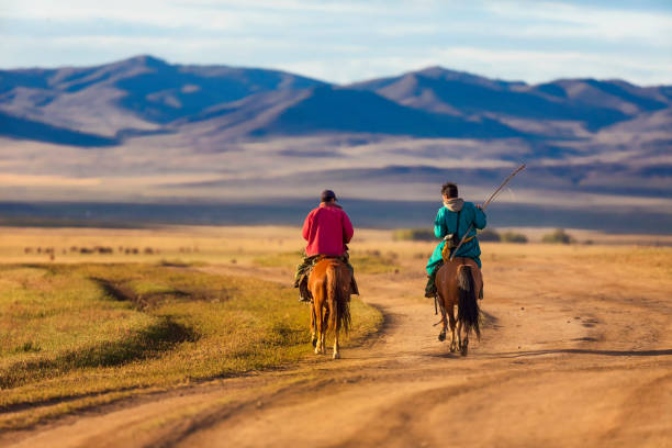 Horse rider in Mongolia Erdenet, Mongolia, 15nd September 2019: rider in a landscape of Western Mongolia altai mountains stock pictures, royalty-free photos & images