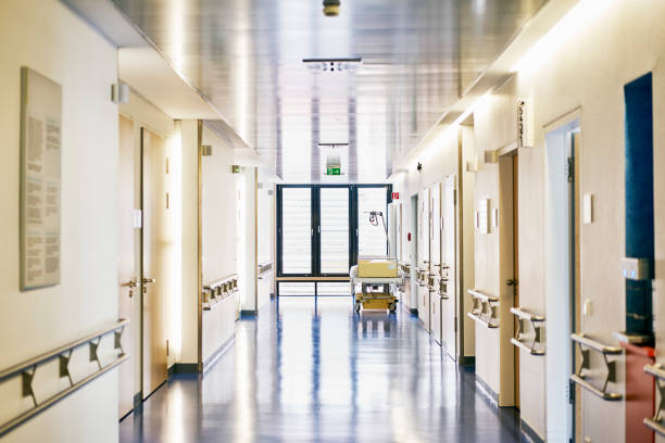 hospital bed corridor nobody landscape format Hospital with corridor and bed without persons in landscape format corridor stock pictures, royalty-free photos & images