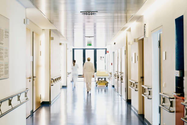 hospital doctor nurse blurred from behind Hospital with corridor bed doctor and nurse with motion blur from behind corridor stock pictures, royalty-free photos & images