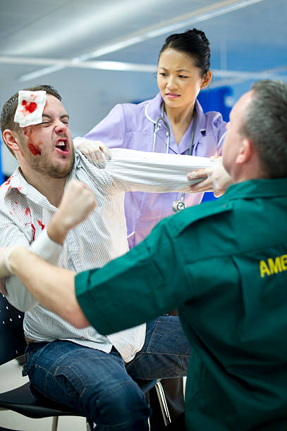hospital violence drunk patient strikes out at hospital staff restraining stock pictures, royalty-free photos & images