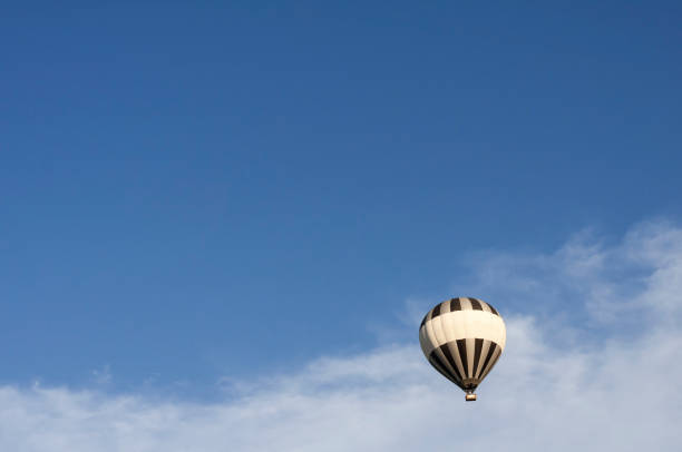 Hot air balloon floating in the air Airborne hot air balloon with copy space. zero gravity carnival ride stock pictures, royalty-free photos & images