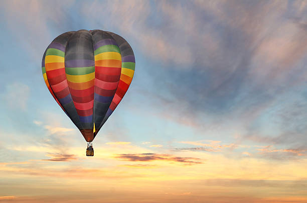 hot air balloon in colorful sunrise sky stock photo