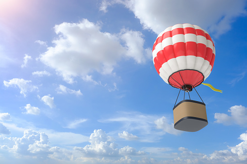 Hot air balloon in flight on the clear sky . Multi Colored air balloon . Traveling by air