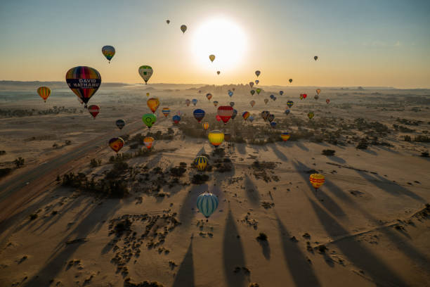 Hot Air Balloons fly over Mada'in Saleh (Hegra) ancient site during the 2020 Winter at Tantora Festival, Al Ula, Saudi Arabia Winter at Tantora Festival is an annual festival held in the old town of Al-Ula, Medina which is located in northwestern Saudi Arabia. The festival began on December 21, 2018, hosting a series of weekend concerts for world-class musicians, hot air balloons festival, and heritage and cultural sites. outcrop stock pictures, royalty-free photos & images