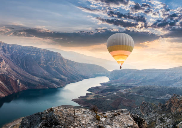 Hot air balloons flying over the Botan Canyon in TURKEY stock photo