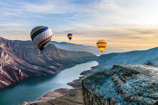 Hot air balloons flying over the Botan Canyon in TURKEY