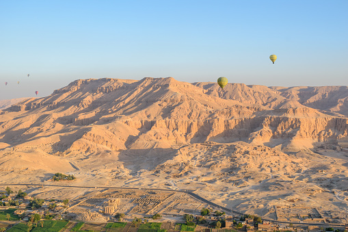 Theban Necropolis, Luxor, Egypt - July 27, 2022: Hot air balloons flying over the ancient wonders of Luxor, the world's largest open-air museum, during sunrise.  

The Ramesseum of Pharaoh Ramesses II, Valley of the Kings, Mortuary Temple of Hatshepsut and Valley of the Queens are among the things that can be seen when flying in a hot air balloon over the Theban Necropolis.