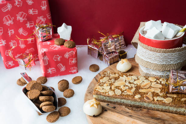 warme chocolademelk met marshmallows, kruidnoten, pop, voor nederlandse evenement sinterklaas, tegen rode achtergrond - sinterklaas cadeaus stockfoto's en -beelden
