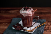 istock Hot Chocolate with whipped cream,cinnamon and star anise served on a wooden table 1345963730