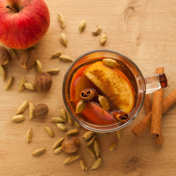 Hot tea with cardamom and cinnamon with apple flavor stock photo