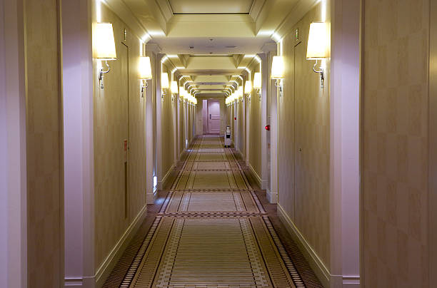 Hotel style, cream colored hallway with lamps stock photo