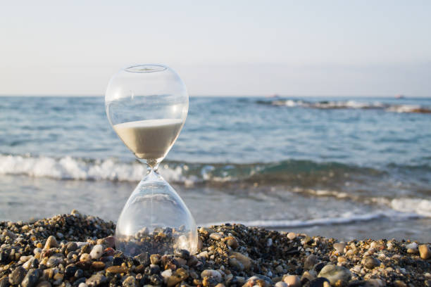 Best Hourglass Clock On The Sand Beach Stock Photos, Pictures & Royalty ...